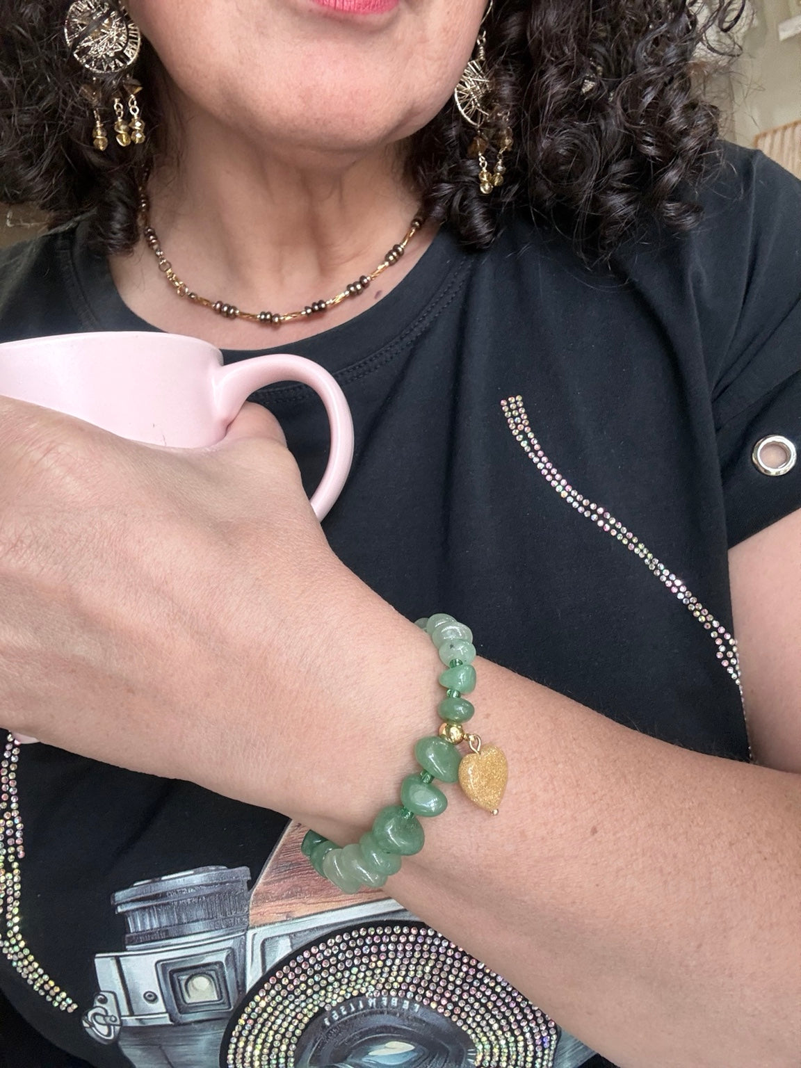Pulsera de aventurina verde con dije de corazón en jade mostrada en la muñeca.